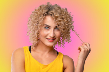Fototapeta premium curly blonde girl on a bright background