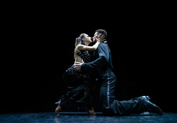Couple of dancers performing on isolated black background