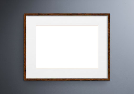Empty frame. Blank dark wood mounted landscape frame on grey wall