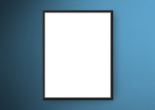 Empty frame. Blank black mounted portrait frame on blue wall