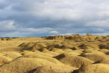 artificial mountains of crushed stone and sand at a quarry for the extraction of building limestone.