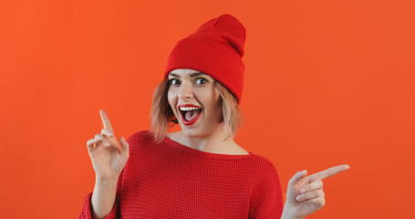 Portrait of happy smiling young sexy girl red hat listening to music dancing and waving her hands...