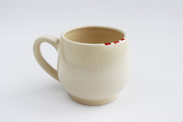 ceramic mug with red spots painted with overglaze paint. handmade.