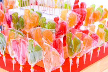 several multi-colored star-shaped lollipops at a fair
