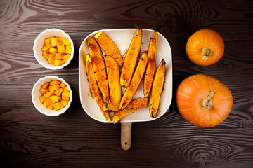 Slices of baked pumpkin in white ceramic bowl