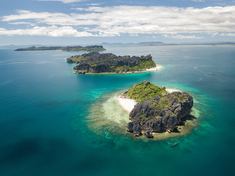 drone aerial panorama of pristine uninhabited island with untouched beach, corals andbizarre tsingy rock formation/ madagascar/ nosy hara