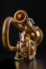 Mouthpiece of an old trumpet covered with patina. Musical instrument shown in magnification.