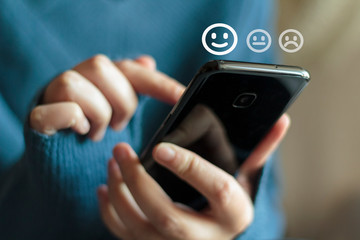 Woman using phone for service rating and customer satisfaction