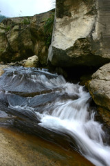 Fototapeta na wymiar Long time exposure shot of a creek and rocks