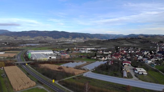 Aerial view of federal road with a village and mountains in the background