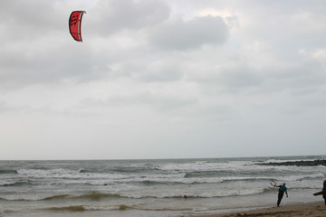 People playing Kitesurfing on a storm day