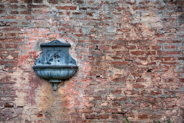 Antique drinking fountain - sprue - spout on a train station