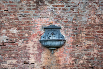 Antique drinking fountain - sprue - spout on a train station