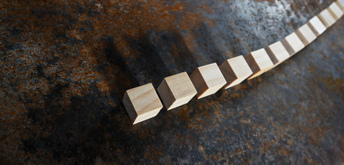 A row with wooden blocks on a rusty metal plate