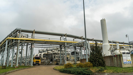 Panoramic view of the oil terminal with yellow tanker truck. Petrochemical concept.