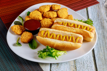 Fast food concept. Hot dog with chicken nuggets.