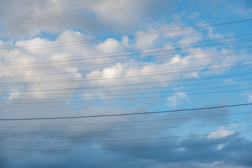 Wires across a clouded sky