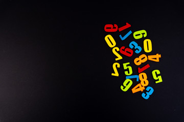 Colorful numbers on black background with educational concept.