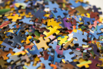 pieces of jigsaw puzzle in a heap - obrazy, fototapety, plakaty