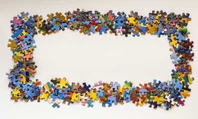 Jigsaw puzzle pieces arranged in a frame shape