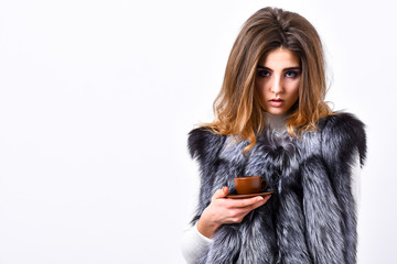 Woman splendid makeup wearing luxurious fur coat drinking hot coffee. Elite coffee concept. Pretty lady drink coffee little ceramic cup white background. Enjoy luxurious aroma and taste hot coffee