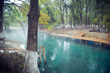 thermal water river, photo of morning fog over a lake in cold autumn weather in half moon san luis potosi