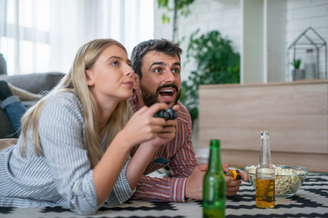 Young couple playing video games in the living room