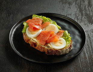 slice of bread with egg and salmon