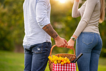 Couple walking in the park with picnic basket,close up.