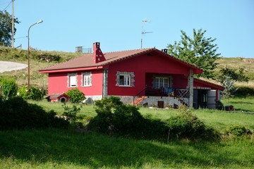a red house in the field