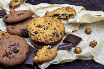 Freshly baked American chocolate chip cookies on rustic black metal table background