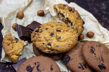 Freshly baked American chocolate chip cookies on rustic black metal table background