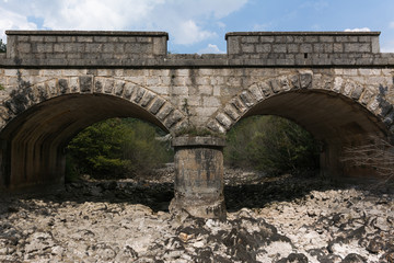 Old stone bridge and dry riverbed in hot summer. Knin in Croatia.