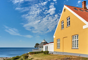 Traditional yellow house on a hill in Svaneke, Bornholm island, Denmark