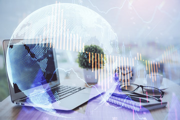 Stock market graph on background with desk and personal computer. Multi exposure. Concept of financial analysis.