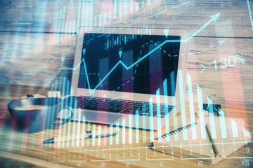 Multi exposure of graph and financial info and work space with computer background. Concept of...