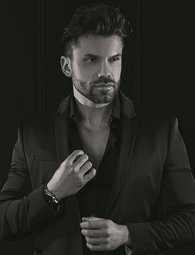 Man in elegant black suit posing