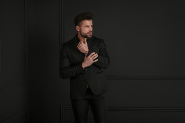 Man in elegant black suit posing