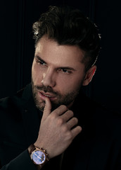 Man in elegant black suit posing