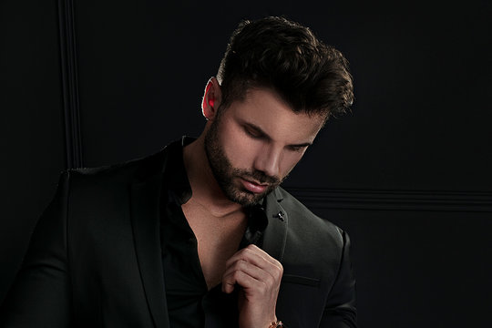 Man in elegant black suit posing