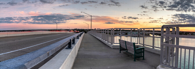 Bench view of a Golden sunset the SS Jolley Bridge into Marco Island