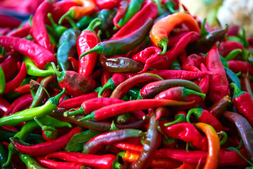 Red hot chili peppers on a bazaar counter, close-up, with shallow depth of field