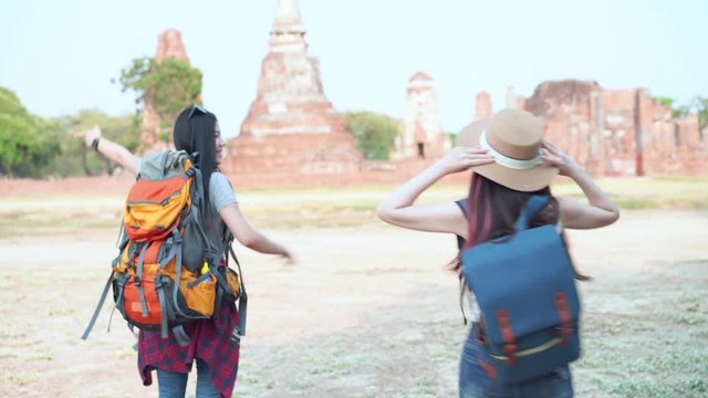 Two female Tuk Tuk passenger standing ahead Ayutthaya Historical Park for travel