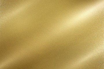 Light shining down on gold foil metal wall with copy space, wallpaper background