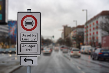 german street sign diesel driving ban in the downtown with a blurred background of city traffic,...