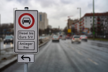 german street sign diesel driving ban in the downtown with a blurred background of city traffic,...