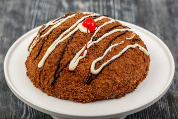Dessert chocolate cake with white and dark chocolate glaze with chocolate chips