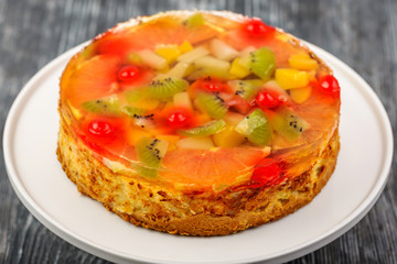 Dessert cheesecake of butter dough with pieces of fruit in jelly