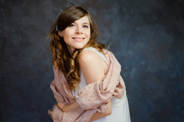 Naklejka premium Portrait of charming caucasian girl with wavy hair. Feminine young woman smiling posing on dark background. Natural beauty.