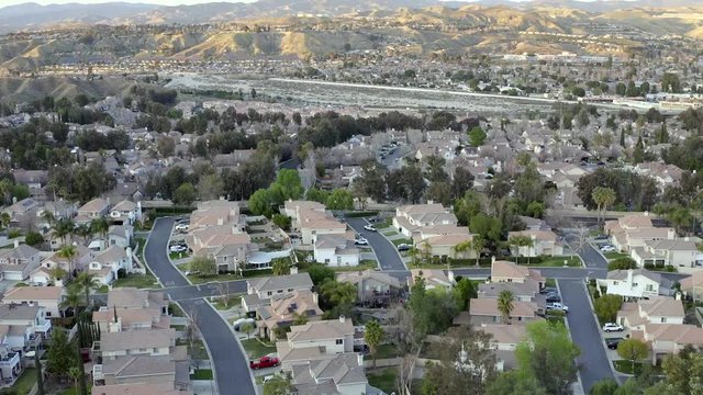 Aerial drone rising of Santa Clarita residential neighborhood during sunset, California